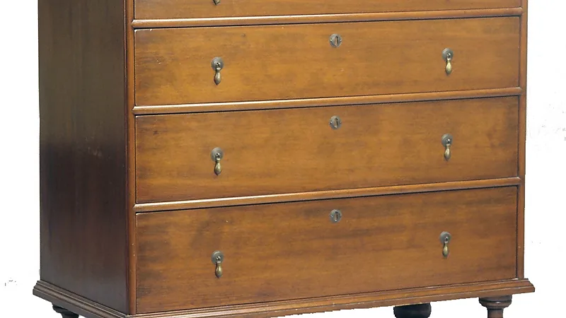 Plain wooden chest of drawers with brass drop handles on a white background, the kind of piece suited to chalk paint